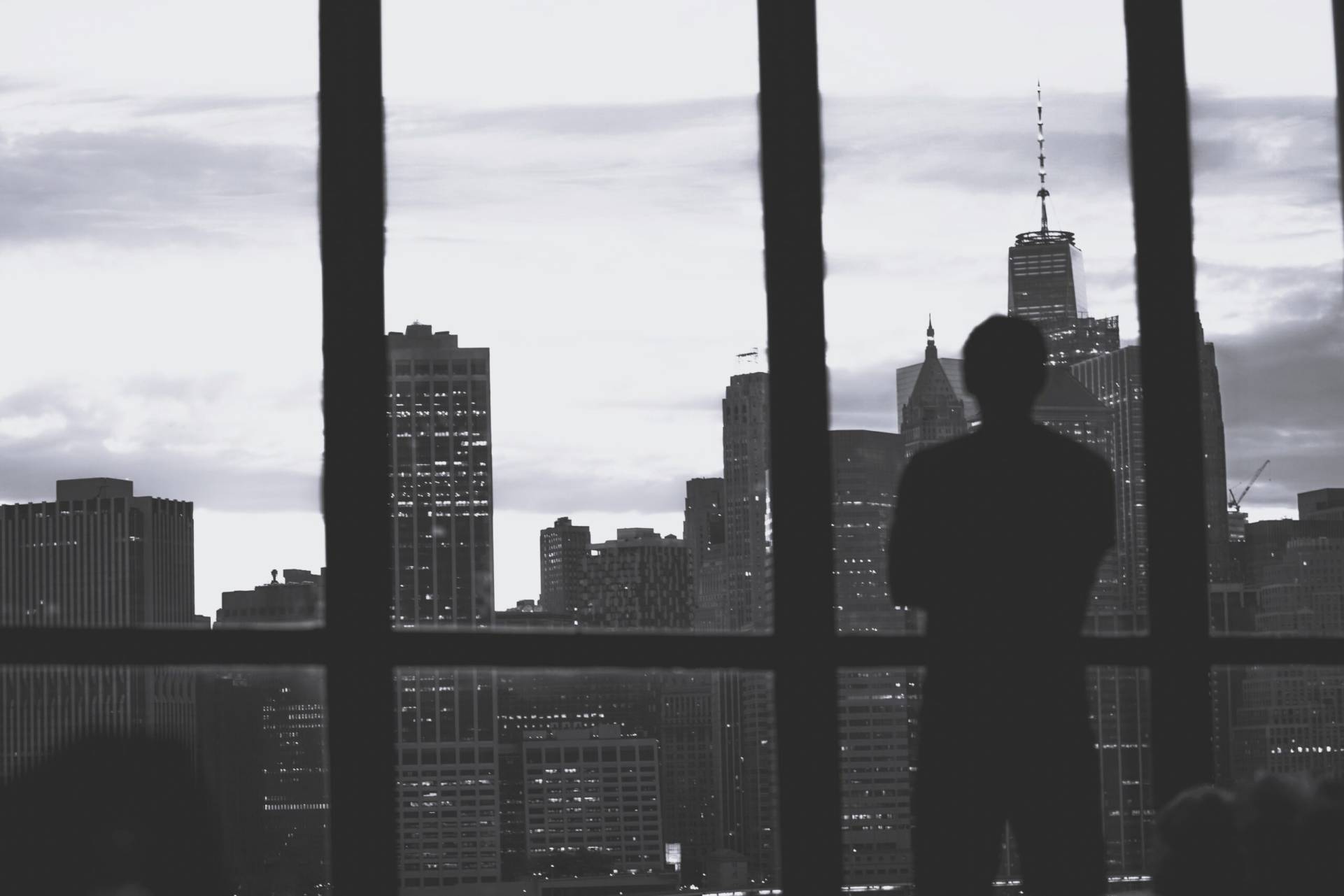 silhouette successful male standing window overlooking island manhattan scaled